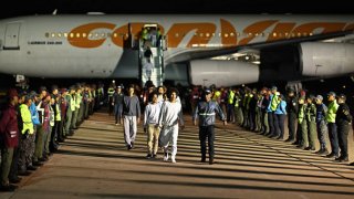 Venezuelan migrants deported from the United States and stranded in Honduras disembark from a Conviasa Airlines plane upon arrival at Simon Bolivar International Airport in Maiquetia, Venezuela on March 24, 2025.