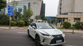 A Pony.ai robotaxi drives on a public road in a suburb in southern Beijing on July 11, 2024.