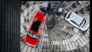 A Volkswagen (VW) Passat R car (L) and a Golf GTI car are pictured in the tower storage facility of German carmaker Volkswagen at the company’s headquarters in Wolfsburg, central Germany, on March 11, 2025.