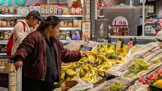 Customers shop for fresh fruits and vegetables in a supermarket in Munich, Germany, on March 8, 2025.