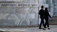 Pedestrians walk towards the Harvard Medical School, Thursday, Aug. 18, 2022, in Boston.