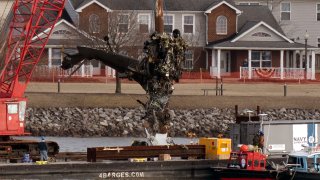 File. Salvage crews pull up a part of a Black Hawk helicopter near the site in the Potomac River of a mid-air collision between an American Airlines jet and a Black Hawk helicopter at Ronald Reagan Washington National Airport, Thursday, Feb. 6, 2025, in Arlington, Va.