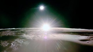 This image provided by NASA/Firefly Aerospace, Tuesday, March 18, 2025, shows the sun setting on the moon, with Earth and Venus in the distance. (NASA/Firefly Aerospace via AP)