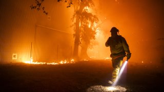 File - A firefighter at the Soda Rock Vineyards during the Kincade fire in Healdsburg, California, on Oct. 27, 2019.