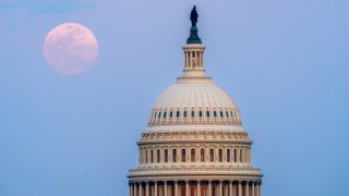 WASHINGTON, DC – MARCH 13: The Full Worm Moon rises behind the U.S. Capitol dome at dusk on March 13, 2025, in Washington, DC. (Photo by J. David Ake/Getty Images)