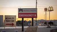 Signs point the way to measles testing in the parking lot of the Seminole Hospital District across from Wigwam Stadium on Feb. 27, 2025 in Seminole, Texas.