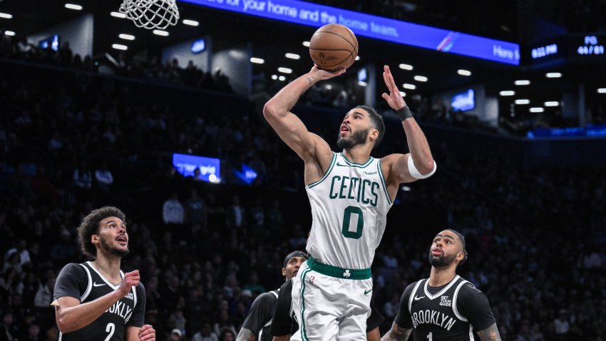 Mar 15, 2025; Brooklyn, New York, USA; Boston Celtics forward Jayson Tatum (0) shoots the ball while being defended by Brooklyn Nets forward Cameron Johnson (2) during the second half at Barclays Center. Mandatory Credit: John Jones-Imagn Images