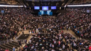 Attendees arrive at the auditorium of the CHI Health Center during the Berkshire Hathaway annual meeting in Omaha, Nebraska, US, on Saturday, May 6, 2023.