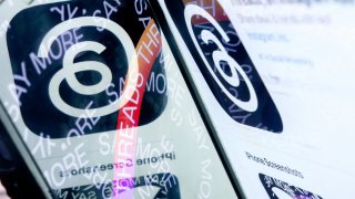 This photo illustration created  in Washington, DC, on July 6, 2023, shows the logo for Threads, an Instagram app, reflected in its opening page. 