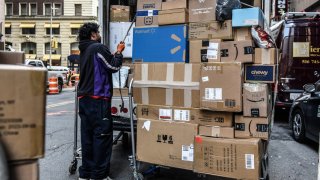 A driver for an independent contractor to FedEx delivers packages on Cyber Monday in New York, US, on Monday, Nov. 27, 2023.