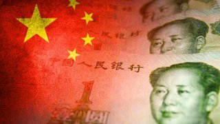 An artwork juxtaposing Chinese yuan cash bills with the China’s flag