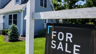 A for-sale sign hangs in front of a house in Patchogue, New York, on June 1, 2024.