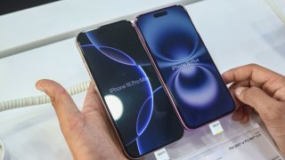 A customer checks Apple’s latest iPhone 16 Plus (right) and Apple’s latest iPhone 16 Pro Max (left) series displayed for sale at Master Arts Shop in Srinagar, Jammu and Kashmir, on Sept. 26, 2024.