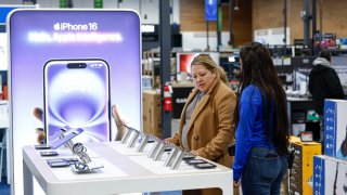 A shopper browse through iPhone section at a Best Buy store on Black Friday in Burbank, Illinois, on Nov. 29, 2024.