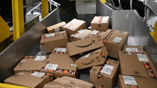 Packages with the logo of Amazon are transported at a packing station of a redistribution center of Amazon in Horn-Bad Meinberg, western Germany, on Dec. 9, 2024.