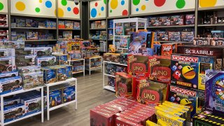 Toys made by Mattel, Hasbro and others are seen at a Macy’s store in New York.