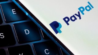 FILE PHOTO: A smartphone with the PayPal logo is placed on a laptop in this illustration taken on July 14, 2021.