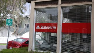 A State Farm logo is seen in front of a State Farm insurance office on February 03, 2025 in Larkspur, California.