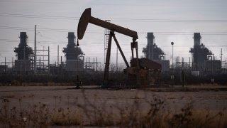 A pump jack operates near a gas turbine power plant in the Permian Basin oil field outside of Odessa, Texas, U.S. February 18, 2025. 