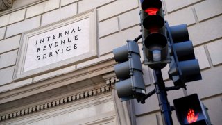 A traffic light is red outside the U.S. Internal Revenue Service building in Washington, D.C., on Feb. 20, 2025.