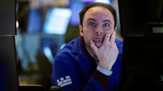 Traders work on the floor at the New York Stock Exchange (NYSE) in New York City, U.S., March 19, 2025. 