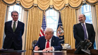US President Donald Trump, alongside Secretary of Treasury Scott Bessent (L) and Secretary of Commerce nominee Howard Lutnick (R), signs an executive order to create a US sovereign wealth fund, in the Oval Office of the White House on February 3, 2025, in Washington, DC.