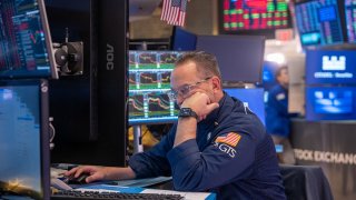 Traders work on the floor of the New York Stock Exchange on March 28, 2025, in New York City.
