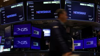 Screens display the trading information for Newsmax Inc. during the company’s IPO on the floor at the New York Stock Exchange on March 31, 2025.