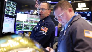 Traders works on the floor of the New York Stock Exchange (NYSE) at the opening bell in New York City.