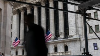 People walk by the New York Stock Exchange (NYSE) before the Closing Bell and the start of President Donald Trump’s news conference on tariffs on April 2, 2025 in New York City.