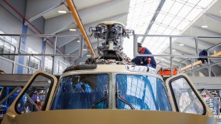 Workers assemble a Leonardo AW139 helicopter on the production floor at the Leonardo plant in Varese, Italy, on Thursday, March 20, 2025.