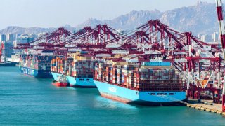 Aerial view of containers for export sitting stacked at Qingdao Qianwan Container Terminal on April 5, 2025 in Qingdao, Shandong Province of China.