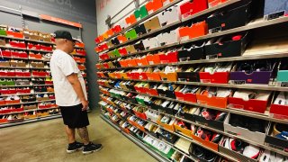 A man shops for shoes at a Nike outlet store in Los Angeles, California on April 10, 2025.