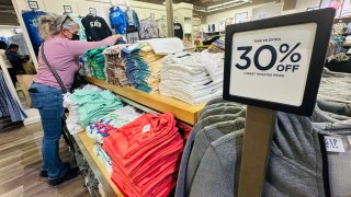 A woman shops for clothing from a Gap outlet store in Los Angeles, California on April 10, 2025.
