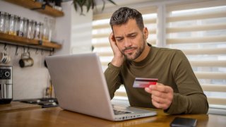 Man is shopping online and using a credit card