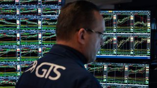 Traders work on the floor of the New York Stock Exchange during morning trading on April 14, 2025 in New York City.