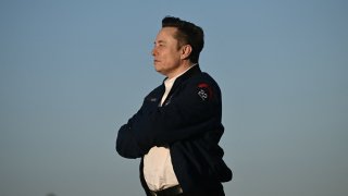 Elon Musk steps off Air Force One upon arrival at Morristown Municipal Airport in Morristown, New Jersey, on March 22, 2025. US President Donald Trump will be spending the weekend at Trump National Golf Club in Bedminster, New Jersey.