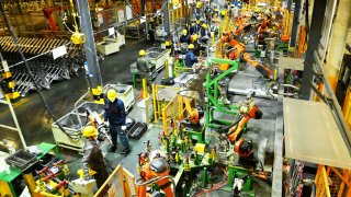 People work on the production line of auto parts at a carmaker in Qingdao in east China’s Shandong province Saturday, March 1, 2025.