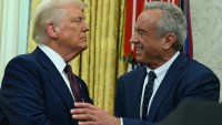The new US Secretary of Health and Human Services Robert F. Kennedy Jr., shakes hands with US President Donald Trump after a swearing in ceremony in the Oval Office of the White House in Washington, DC, on February 13, 2025.