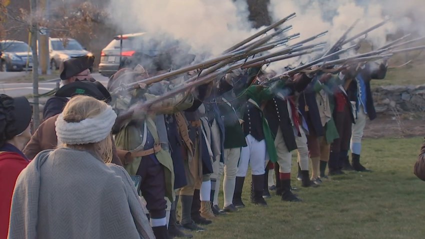 Demonstrators reenact the battles that started the American Revolution.