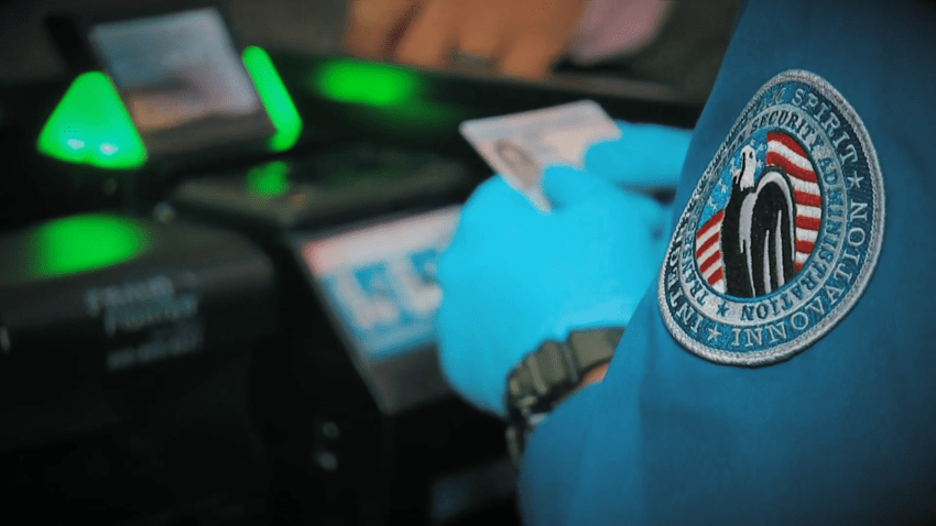 TSA agent holds ID card