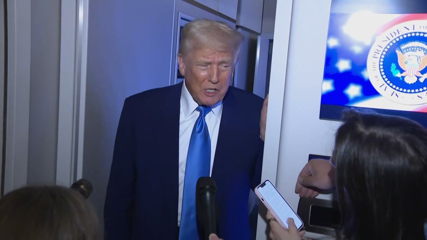 Donald Trump speaks to reporters on Air Force One