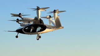 An electric air taxi by Joby Aviation flies near the Downtown Manhattan Heliport in Manhattan, New York City, U.S., November 12, 2023.