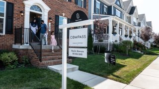 Prospective home buyers leave a property for sale during an Open House in a neighborhood in Clarksburg, Maryland.