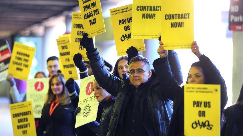 United Airline flight attendants picketed outside Terminal B at Logan Airport Thursday morning seeking a new contract.