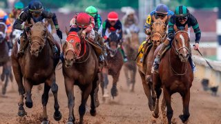 Mystik Dan, with Brian Hernandez Jr. up, right, wins the 150th running of the Kentucky Derby, in a three-way photo finish over second place Sierra Leone and third place Forever Young at Churchill Downs on Saturday, May 4, 2024, in Louisville, Kentucky.