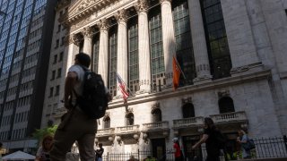 People walk by the New York Stock Exchange (NYSE) on June 18, 2024 in New York City.