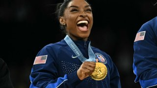 Simone Biles poses with the gold medal during the podium ceremony at the 2024 Paris Olympic Games at the Bercy Arena in Paris on July 30, 2024.