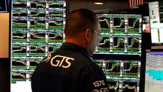 Traders work on the floor of the New York Stock Exchange (NYSE) at the opening bell in New York City.