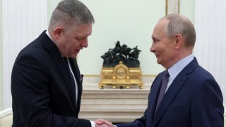 In this pool photograph distributed by Russian state agency Sputnik, Russia’s President Vladimir Putin shakes hands with Slovakia’s Prime Minister Robert Fico prior to their talks in Moscow on Dec. 22, 2024.
